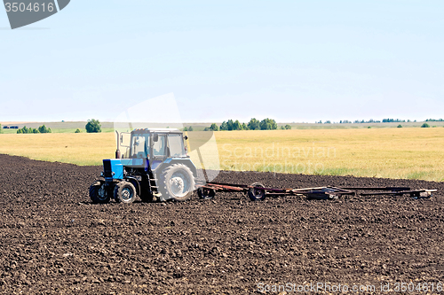 Image of Tractor wheeled plowing