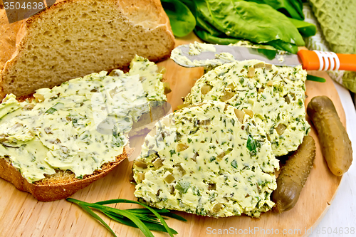 Image of Butter with spinach and bread on board