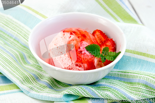 Image of Ice cream strawberry with syrup in bowl on napkin
