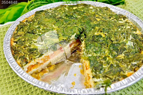 Image of Pie celtic with spinach and tomatoes in form of foil on board