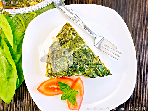 Image of Pie celtic with spinach and tomato in plate on table top