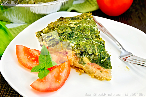 Image of Pie celtic with spinach and tomatoes on table