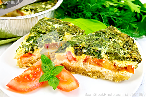 Image of Pie celtic with spinach in plate on board