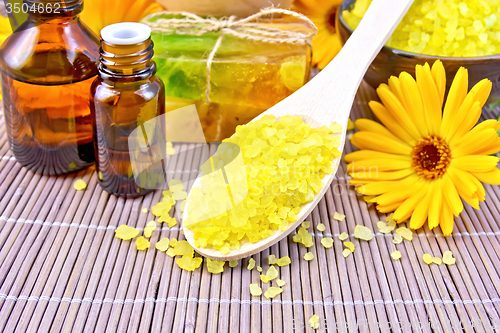 Image of Salt yellow and oil with calendula on bamboo