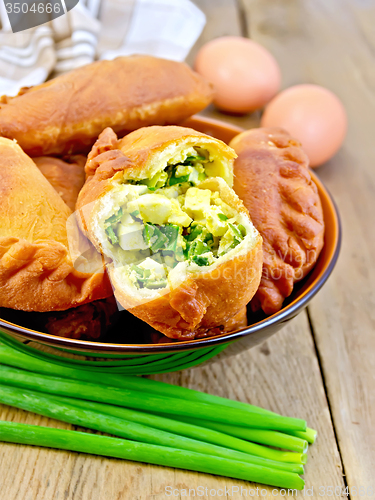 Image of Patties with onion and egg in bowl on board