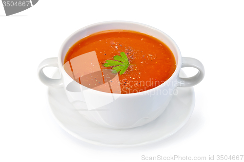 Image of Soup tomato with parsley in white bowl on saucer