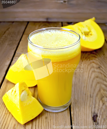 Image of Juice pumpkin in glass on board