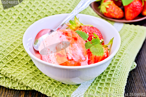 Image of Ice cream strawberry with syrup and mint in bowl on board