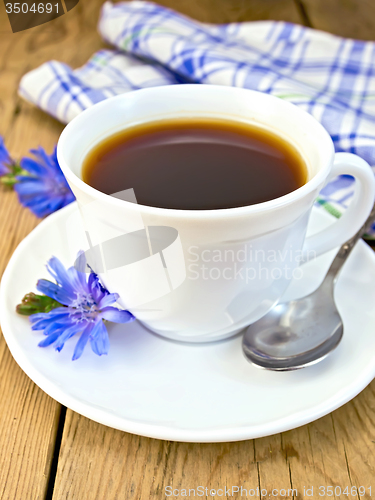 Image of Chicory drink in white cup with flower on board