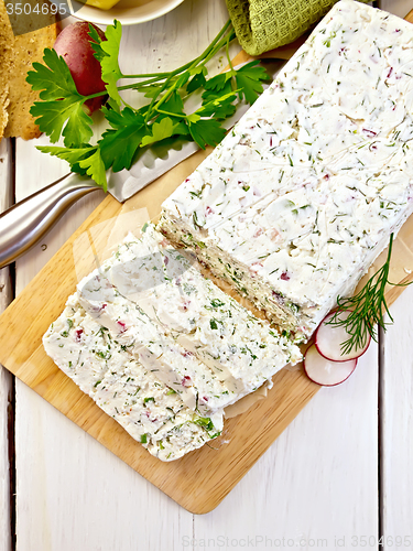 Image of Terrine of curd and radish on paper and board top