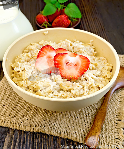 Image of Oatmeal with strawberry on dark board