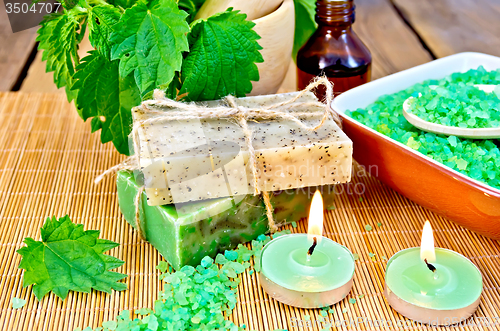 Image of Soap homemade with nettles in mortar on board