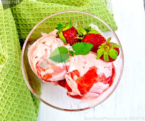 Image of Ice cream strawberry with napkin on board top
