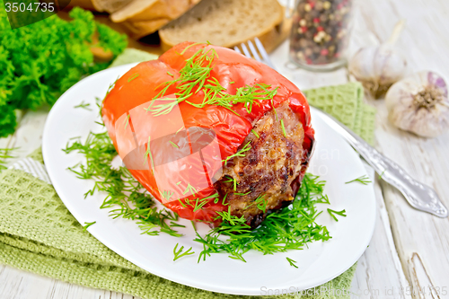Image of Pepper stuffed meat with dill in plate on board