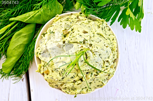 Image of Butter with spinach and herbs in bowl on light board