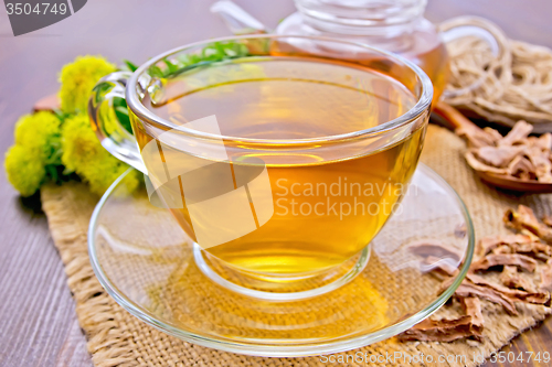 Image of Tea of Rhodiola rosea in glass cup on board