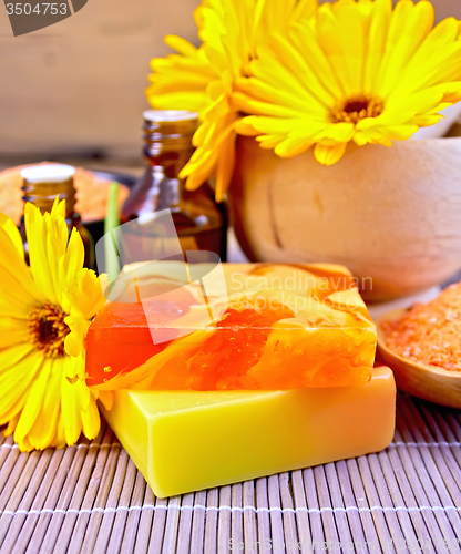 Image of Soap homemade and oil with calendula on bamboo