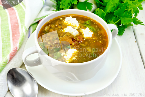 Image of Soup lentil with spinach and cheese on light board