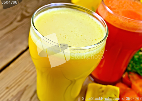 Image of Juice pumpkin and carrot on wooden board