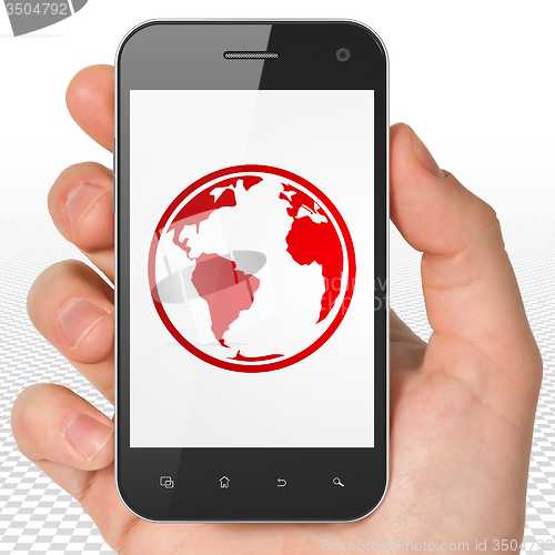 Image of Learning concept: Hand Holding Smartphone with Globe on display