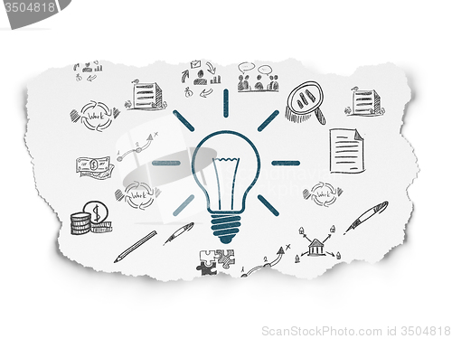Image of Finance concept: Light Bulb on Torn Paper background