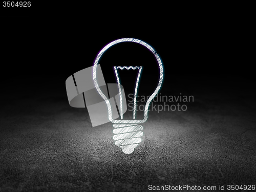 Image of Finance concept: Light Bulb in grunge dark room