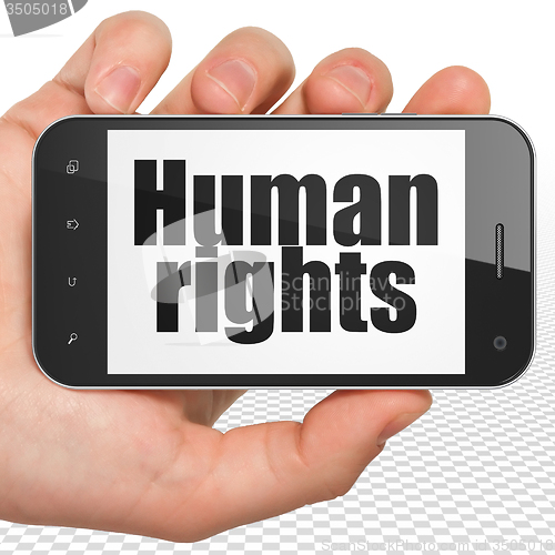 Image of Politics concept: Hand Holding Smartphone with Human Rights on display