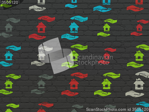 Image of Insurance concept: House And Palm icons on wall background