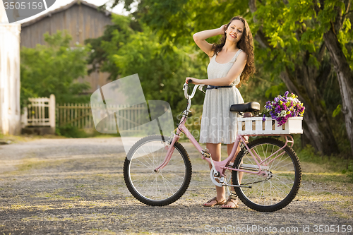 Image of Happy girl with her bicycle