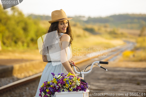 Image of Happy girl with her bicycle