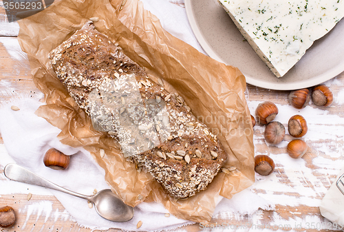 Image of Bread with seeds cheese and huzelnuts on wooden board