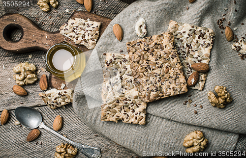 Image of dietic cookies honey and nuts on rustic table