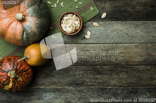 Image of pumpkins and seeds in Rustic style on wood 