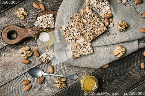 Image of Cookies with seeds, nuts, honey on wooden table