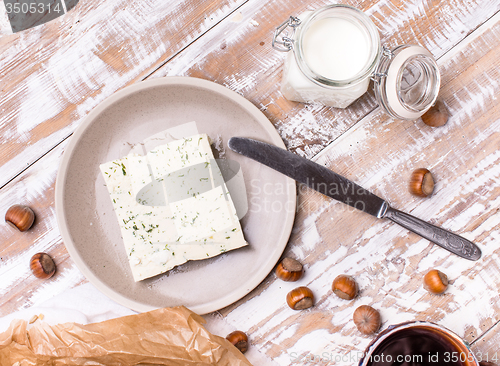 Image of cheese with dill and joghurt for breakfast on wooden table