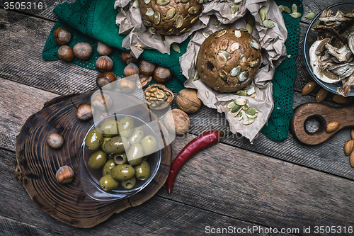 Image of healthy eating olives, nuts mushrooms  and bread buns 