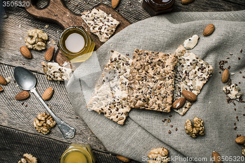 Image of dietary Cookies with  honey and nuts on napkin and wooden table