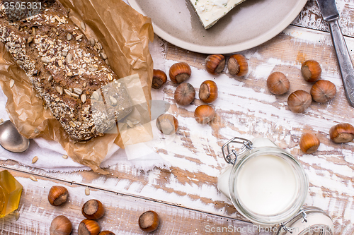 Image of Healthy meal Bread with seeds huzelnuts and cheese on table