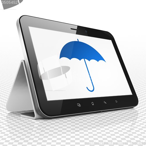 Image of Protection concept: Tablet Computer with Umbrella on display