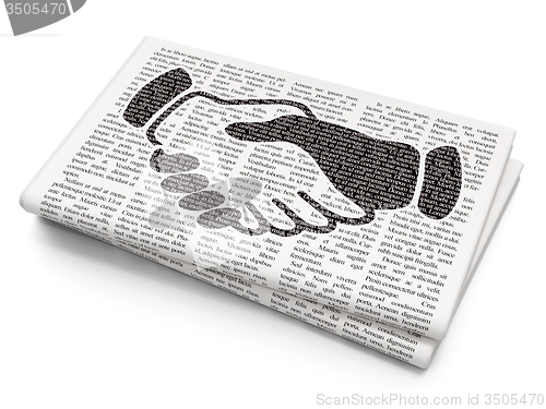 Image of Finance concept: Handshake on Newspaper background