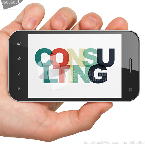 Image of Finance concept: Hand Holding Smartphone with Consulting on  display