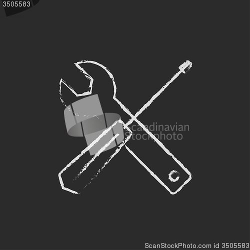 Image of Screwdriver and wrench tools icon drawn in chalk.