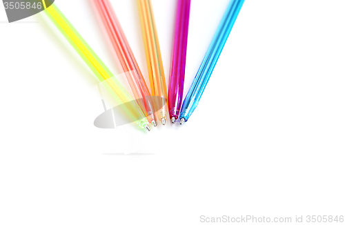 Image of Colorful pens on white background