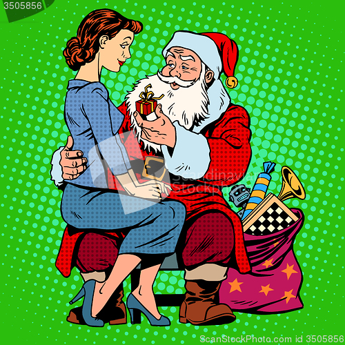 Image of Christmas gift. Santa Claus and a beautiful girl