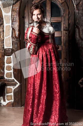 Image of Beautiful woman in red dress in retro baroque style