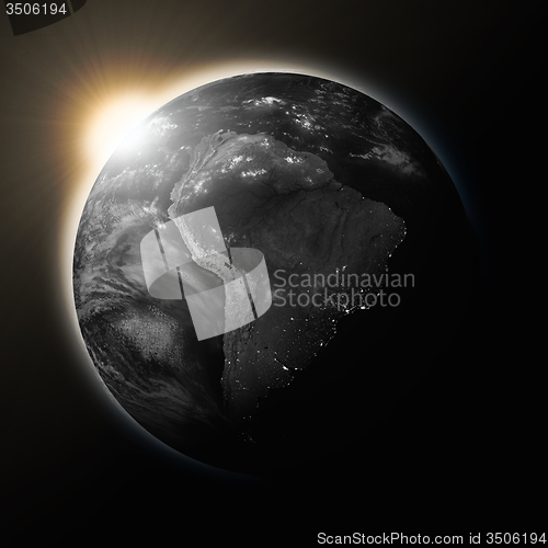 Image of Sun over South America on dark planet Earth