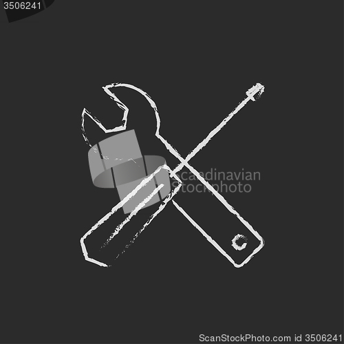 Image of Screwdriver and wrench tools icon drawn in chalk.