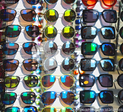 Image of in london glass and sunglasses in the light and reflex