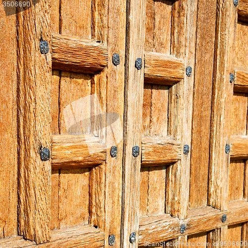 Image of door    in italy old ancian wood and traditional  texture nail
