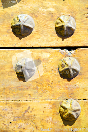 Image of metal nail dirty stripped paint in the    yellow  